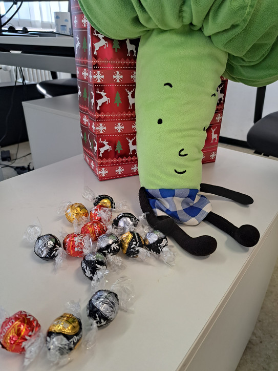 Eine Brokkolihandpuppe mit Lindorkugeln