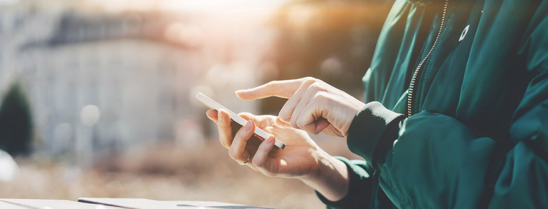  A person types in something on a smartphone