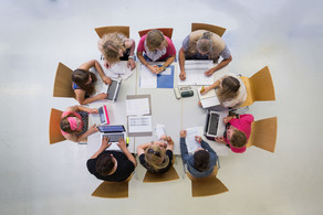 People sitting in a circle talking shot from above.